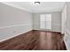 Room features updated hardwood floors, large window for natural light, and chair rail at 185 Waverly Walk, Douglasville, GA 30134