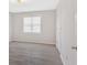 Bright room with natural light showcases updated hardwood floors and white trim at 185 Waverly Walk, Douglasville, GA 30134