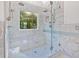 Luxury shower with dual shower heads, glass enclosure, marble tile, and a built-in bench at 185 Waverly Walk, Douglasville, GA 30134