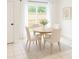 Cozy dining area with a round table, comfortable seating, and natural light from the sliding glass doors at 191 Northdale Pl, Lawrenceville, GA 30046