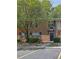 A charming brick townhouse featuring a quaint entrance and well-maintained landscaping at 191 Northdale Pl, Lawrenceville, GA 30046