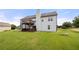 Spacious backyard featuring a home with a deck and balcony, surrounded by lush green grass at 758 Beranda Cir, Douglasville, GA 30134