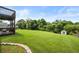 Large backyard with level lawn, mature trees, and a charming storage shed or outbuilding at 758 Beranda Cir, Douglasville, GA 30134