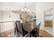 Dining room featuring hardwood floors, a chandelier, a large table, and stairs to the second floor at 758 Beranda Cir, Douglasville, GA 30134