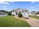 Two-story home with a manicured lawn, stone accents, a driveway, and an attached two-car garage at 758 Beranda Cir, Douglasville, GA 30134