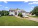 Two-story home with a manicured lawn, stone accents, a driveway, and an attached two-car garage at 758 Beranda Cir, Douglasville, GA 30134
