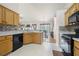 Efficient kitchen with tile backsplash, appliances, and ample counter space, and an adjacent dining area at 758 Beranda Cir, Douglasville, GA 30134