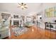 Bright living room featuring hardwood floors, a fireplace, neutral walls, and a ceiling fan at 758 Beranda Cir, Douglasville, GA 30134