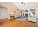 Bright living room featuring hardwood floors, a fireplace, neutral walls, and a ceiling fan at 758 Beranda Cir, Douglasville, GA 30134