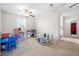 Bright playroom with a ceiling fan, a variety of toys and tables for children at 758 Beranda Cir, Douglasville, GA 30134