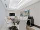 Modern conference room with a large table, sleek white chairs, and a wall-mounted television for presentations at 775 Juniper St # 212, Atlanta, GA 30308