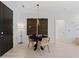 Dining area featuring a round table with stylish chairs, modern lighting, and a decorative accent wall at 775 Juniper St # 212, Atlanta, GA 30308