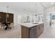Well-lit kitchen with a large island and dining area with contemporary decor and stainless steel appliances at 775 Juniper St # 212, Atlanta, GA 30308