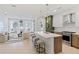 Open-concept kitchen and living room with stainless steel appliances, a quartz countertop island, and modern furnishings at 775 Juniper St # 212, Atlanta, GA 30308