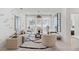 Bright living room featuring a modern sofa, stylish decor, large windows, and a decorative rug on light wood floors at 775 Juniper St # 212, Atlanta, GA 30308