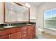 Bathroom with double vanity, granite countertops, and a large framed mirror at 1199 Lavista Ne Rd, Atlanta, GA 30324