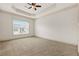 Bedroom featuring neutral carpet, tray ceiling, fan, and a window at 1199 Lavista Ne Rd, Atlanta, GA 30324