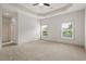 Spacious carpeted bedroom featuring tray ceiling and natural light from multiple windows at 1199 Lavista Ne Rd, Atlanta, GA 30324