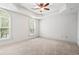 Spacious bedroom with tray ceiling, neutral carpet, and arched windows providing plenty of natural light at 1199 Lavista Ne Rd, Atlanta, GA 30324