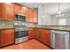Kitchen features stainless steel appliances, wooden cabinets, granite counters, and a tile backsplash at 1199 Lavista Ne Rd, Atlanta, GA 30324