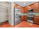 Kitchen with stainless steel appliances, wooden cabinets, pantry, granite counters and tile backsplash at 1199 Lavista Ne Rd, Atlanta, GA 30324