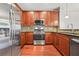 A kitchen featuring stainless steel appliances, wood cabinets, granite counters, and tile backsplash at 1199 Lavista Ne Rd, Atlanta, GA 30324