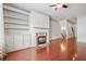 Inviting living area featuring a cozy fireplace, built-in shelving, and gleaming wood floors for a warm ambiance at 1199 Lavista Ne Rd, Atlanta, GA 30324