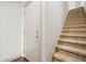 A carpeted staircase ascends past a white entry door, offering a glimpse into the home's interior at 1199 Lavista Ne Rd, Atlanta, GA 30324