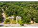 Aerial view showcasing a neighborhood with lush trees and well-maintained homes at 6596 Wright Ne Rd, Atlanta, GA 30328