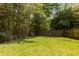 Spacious, well-manicured backyard with a wooden fence, providing privacy and security at 6596 Wright Ne Rd, Atlanta, GA 30328