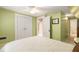 Cozy bedroom includes double door closet, access to a bathroom, and soft green walls at 6596 Wright Ne Rd, Atlanta, GA 30328