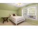 Bright bedroom featuring sloped ceilings, a ceiling fan, and natural light from the windows at 6596 Wright Ne Rd, Atlanta, GA 30328