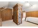 Unique bedroom showcases wood paneling, brick, and carpeted floors under great lighting at 6596 Wright Ne Rd, Atlanta, GA 30328