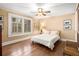 Bright bedroom featuring hardwood floors, a ceiling fan, and a comfortable bed at 6596 Wright Ne Rd, Atlanta, GA 30328