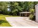 Wide concrete driveway leading to the carport, with a view of the lush greenery surrounding the property at 6596 Wright Ne Rd, Atlanta, GA 30328