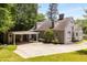 Rear exterior view showcasing a carport and landscaped yard surrounding the grey brick home at 6596 Wright Ne Rd, Atlanta, GA 30328