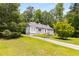 Charming exterior with a well-manicured lawn, long driveway, and beautiful landscape at 6596 Wright Ne Rd, Atlanta, GA 30328