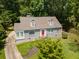 Charming home featuring a well-maintained lawn, a red front door, and a neatly paved driveway at 6596 Wright Ne Rd, Atlanta, GA 30328
