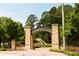 Abernathy Greenway entrance with brick columns and lush landscaping, inviting residents for outdoor adventures at 6596 Wright Ne Rd, Atlanta, GA 30328