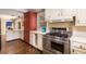 Spacious kitchen with stainless steel appliances, white cabinetry, and hardwood floors at 6596 Wright Ne Rd, Atlanta, GA 30328