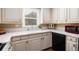 Well-lit kitchen featuring white cabinets, a white tile countertop, and stainless steel appliances at 6596 Wright Ne Rd, Atlanta, GA 30328