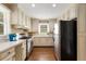 Efficient kitchen layout with stainless steel appliances, ample counter space, and white cabinetry at 6596 Wright Ne Rd, Atlanta, GA 30328