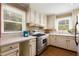 Functional kitchen design featuring stainless steel appliances, white cabinetry, and ample natural light from a window at 6596 Wright Ne Rd, Atlanta, GA 30328