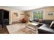 Spacious living room with hardwood floors, comfortable seating, and ample natural light at 6596 Wright Ne Rd, Atlanta, GA 30328