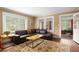 Cozy living room with hardwood floors, a comfortable sofa, and plenty of natural light at 6596 Wright Ne Rd, Atlanta, GA 30328