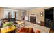 Comfortable living room featuring hardwood floors, fireplace, large windows, and stylish decor at 6596 Wright Ne Rd, Atlanta, GA 30328