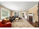 Living room featuring hardwood floors, fireplace, large windows, and comfortable furniture at 6596 Wright Ne Rd, Atlanta, GA 30328