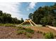 Unique playground structure surrounded by mature trees, perfect for active play and neighborhood enjoyment at 6596 Wright Ne Rd, Atlanta, GA 30328