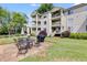 Spacious backyard patio with outdoor seating, barbecue grill, and manicured lawn at 705 Berry Ct, Villa Rica, GA 30180