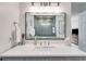 Bathroom featuring gray cabinets, solid surface countertop, and walk-in shower in the mirror's reflection at 705 Berry Ct, Villa Rica, GA 30180